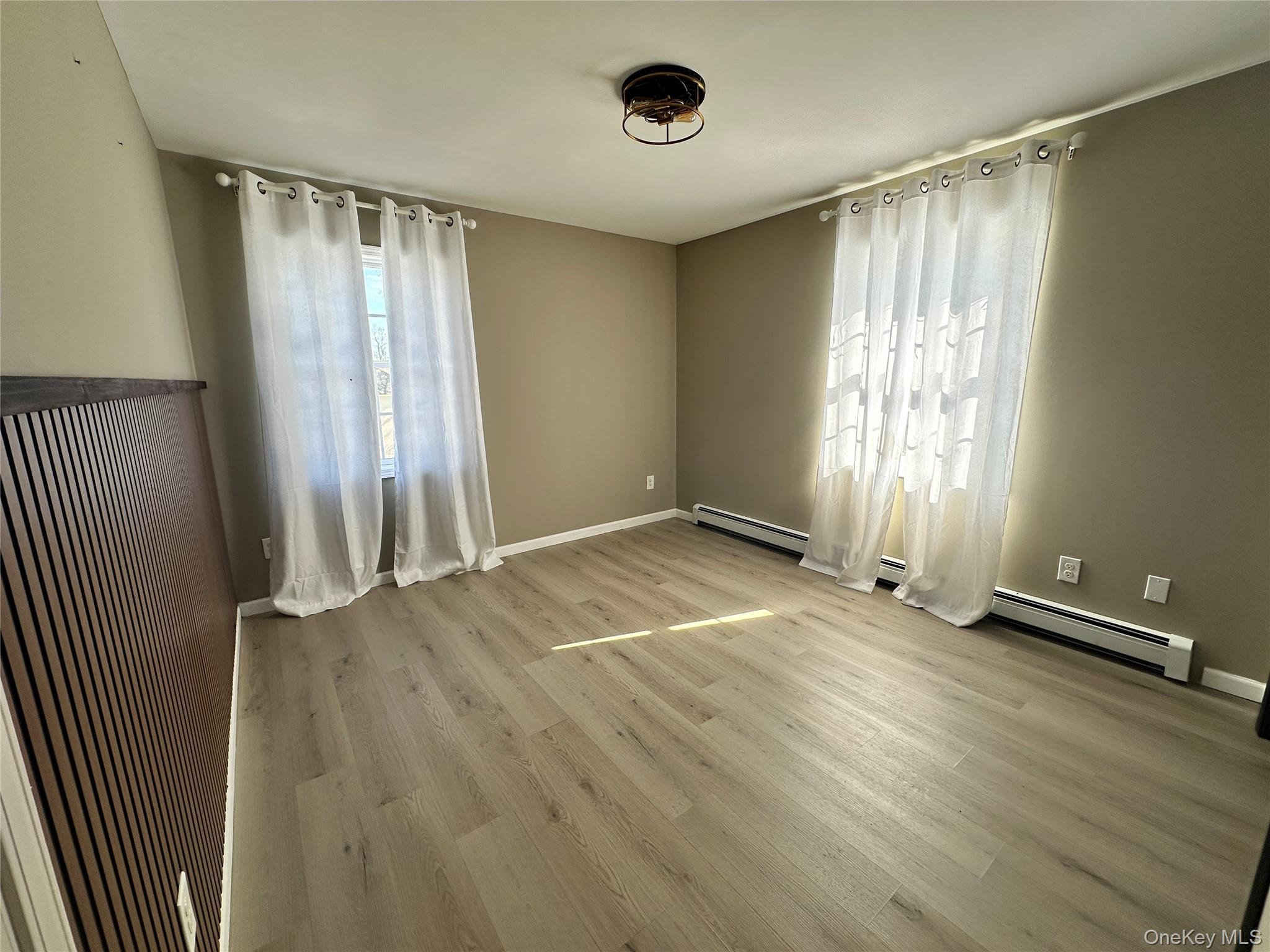 1241 Ridgebury Road New Hampton, NY 10958 - Photo 10 of 21 an empty room with wooden floor and windows