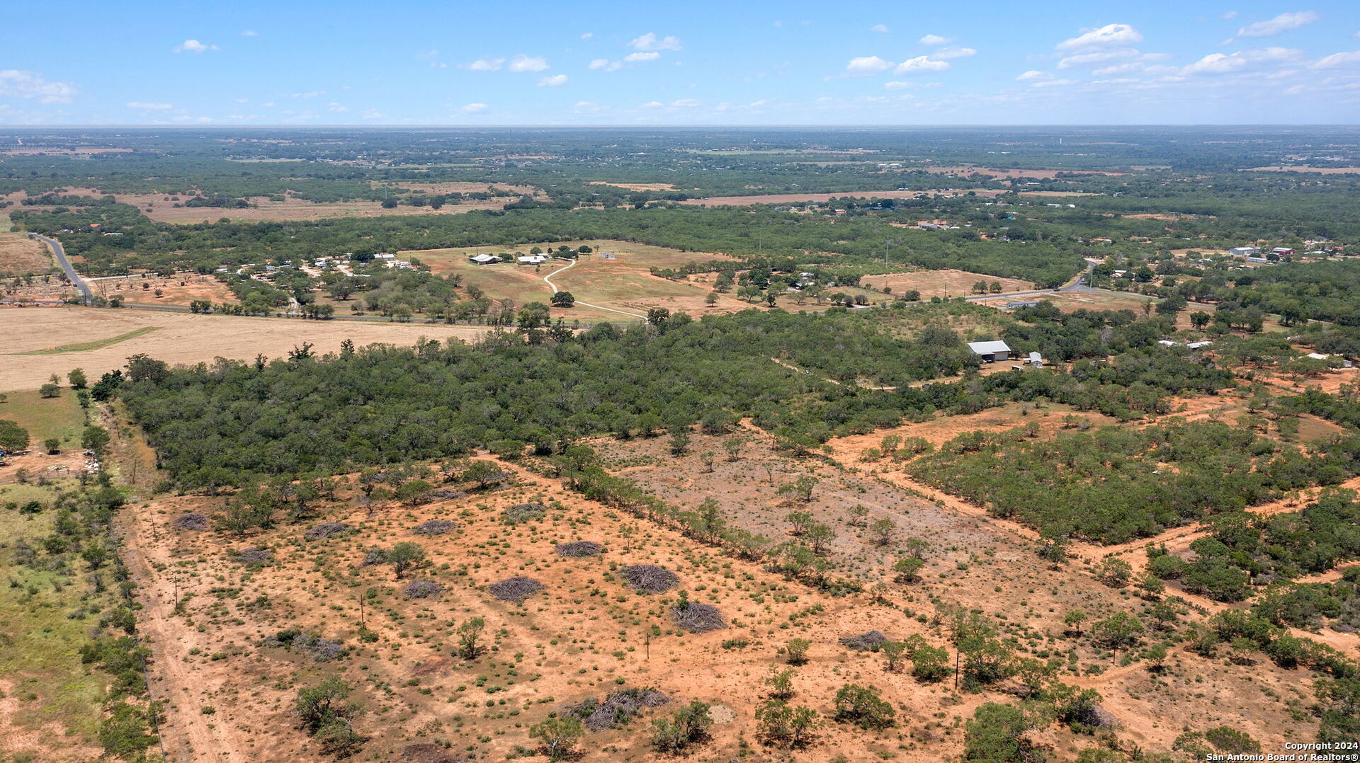 19366 Benton City Road Von Ormy, TX 78073 - Photo 2 of 24 an aerial view of residential houses with outdoor space and trees