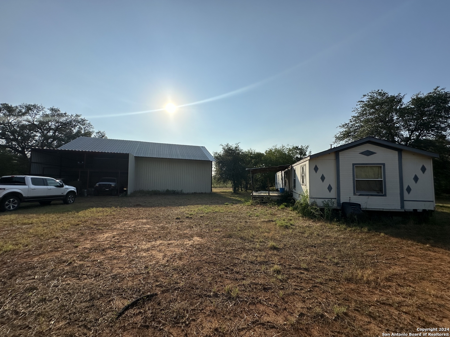 19366 Benton City Road Von Ormy, TX 78073 - Photo 23 of 24 a house view with a backyard space