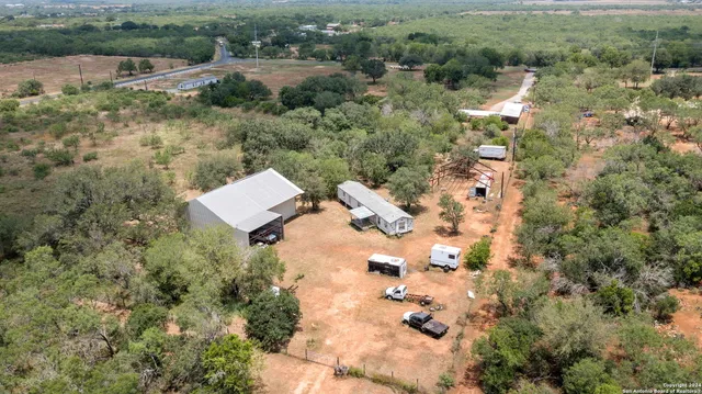 an aerial view of residential house with outdoor space and trees