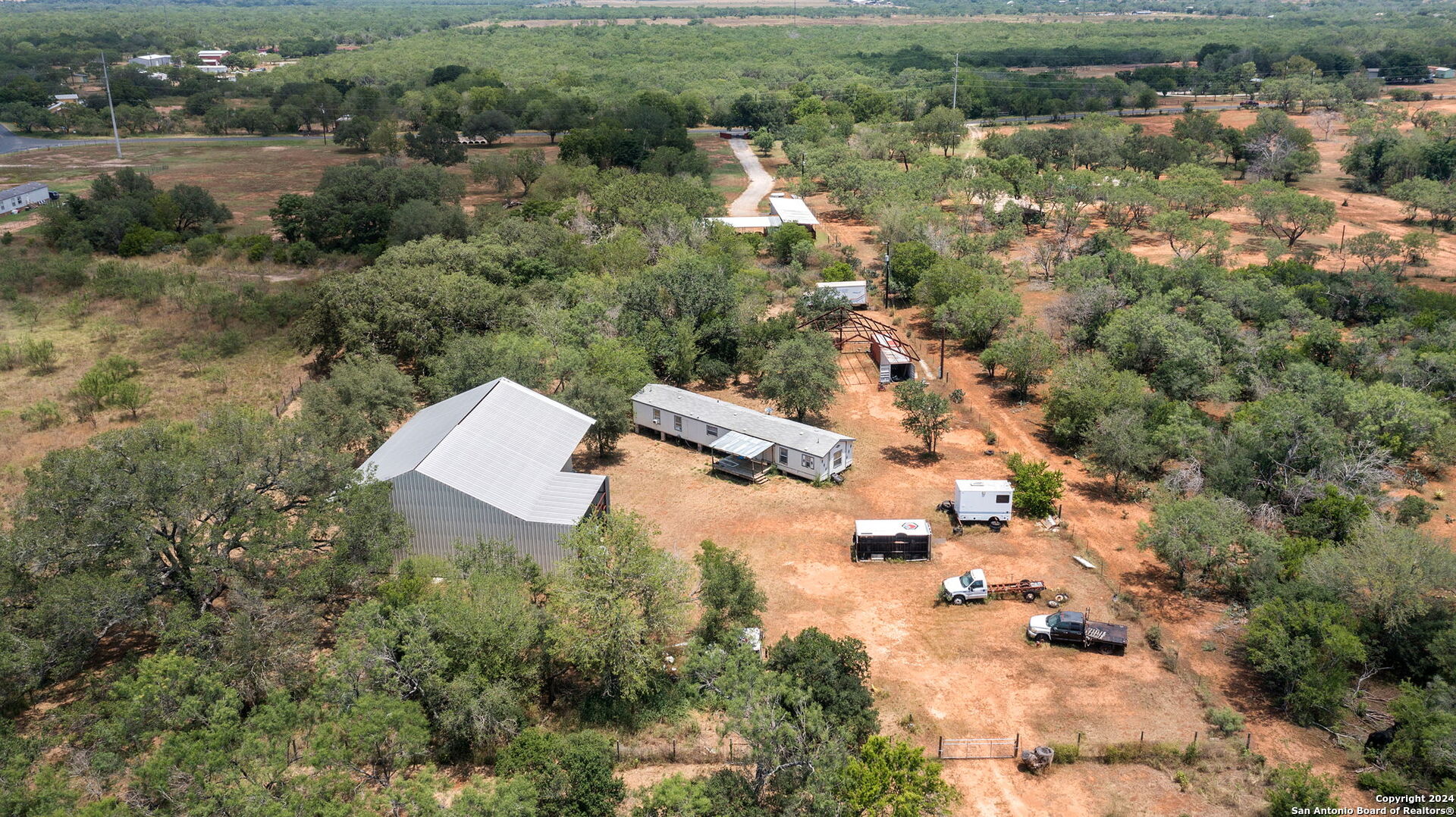 19366 Benton City Road Von Ormy, TX 78073 - Photo 8 of 24 an aerial view of residential house with outdoor space and trees all around