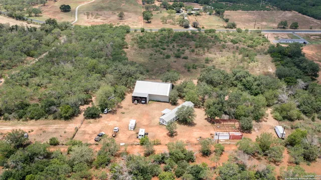 an aerial view of a house with a yard