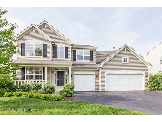 3153 Riley Road Montgomery, IL 60538 - Photo 1 of 15 a front view of a house with a yard and garage
