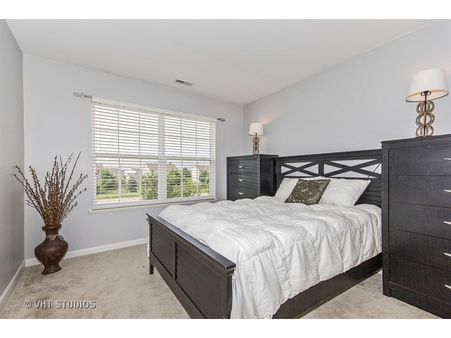 3153 Riley Road Montgomery, IL 60538 - Photo 11 of 15 a bedroom with a large bed and a large window