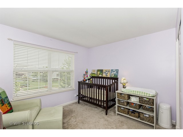 3153 Riley Road Montgomery, IL 60538 - Photo 12 of 15 a bedroom with furniture and a window