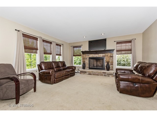 3153 Riley Road Montgomery, IL 60538 - Photo 3 of 15 a living room with furniture window and a fireplace