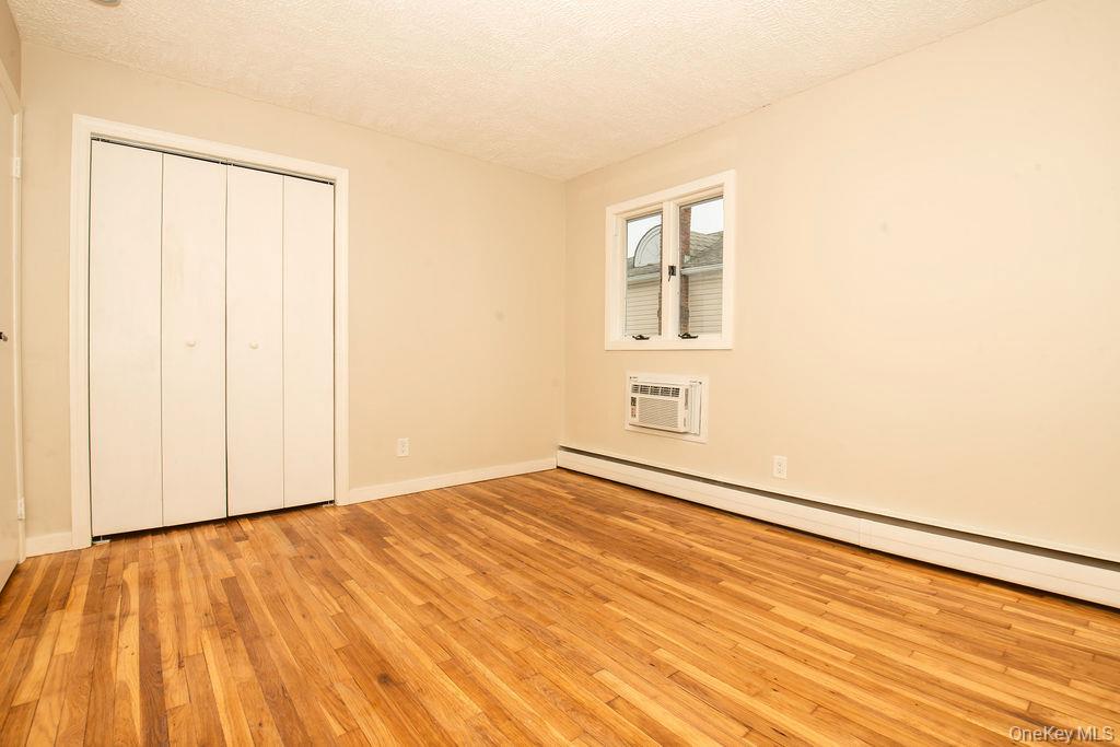 15 East Clearwater Road Lindenhurst, NY 11757 - Photo 11 of 25 a view of an empty room with wooden floor