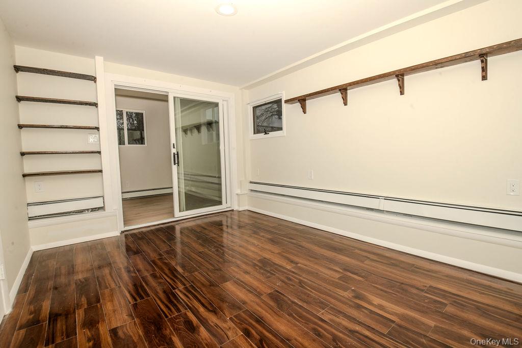 15 East Clearwater Road Lindenhurst, NY 11757 - Photo 19 of 25 a view of an empty room with wooden floor and a window