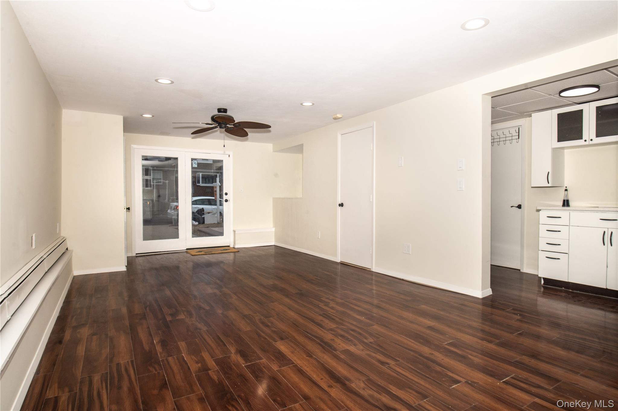 15 East Clearwater Road Lindenhurst, NY 11757 - Photo 22 of 25 a view of a room with wooden floors and ceiling fan
