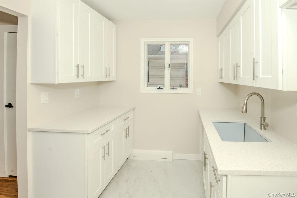 15 East Clearwater Road Lindenhurst, NY 11757 - Photo 3 of 25 a view of a kitchen with sink dishwasher and cabinets