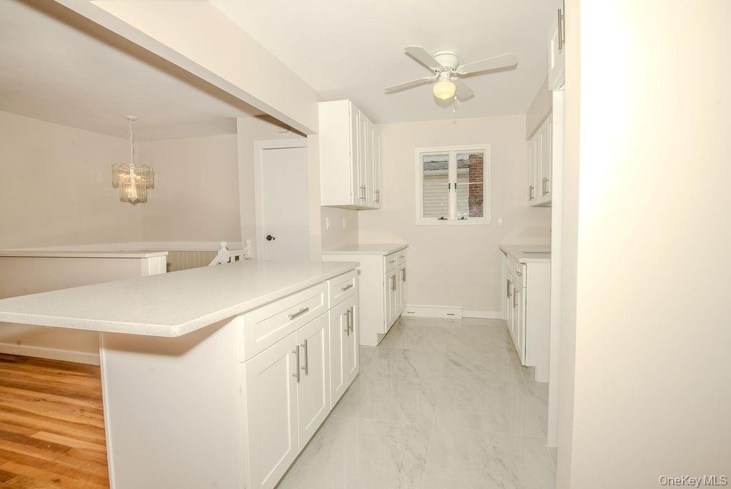 15 East Clearwater Road Lindenhurst, NY 11757 - Photo 4 of 25 a bathroom with a double vanity sink a mirror and a shower