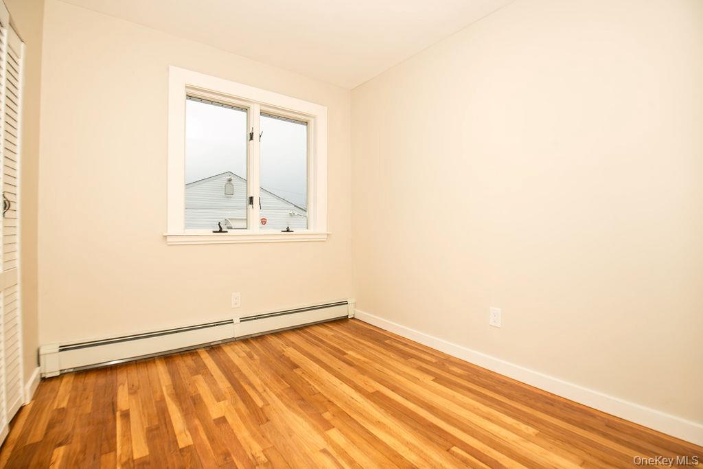 15 East Clearwater Road Lindenhurst, NY 11757 - Photo 5 of 25 an empty room with a window
