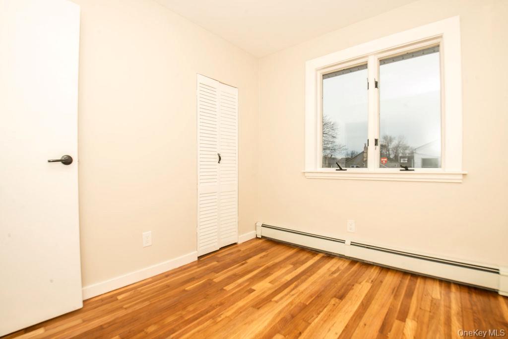 15 East Clearwater Road Lindenhurst, NY 11757 - Photo 6 of 25 a view of a room with wooden floor and a window