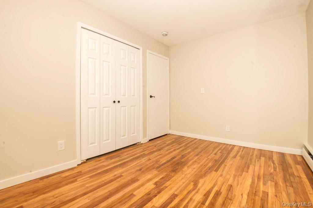 15 East Clearwater Road Lindenhurst, NY 11757 - Photo 8 of 25 a view of empty room with wooden floor