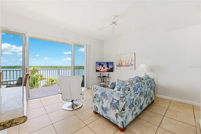 a living room with furniture and a dining table