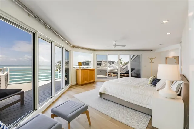 a bedroom with a large bed and a view of living room