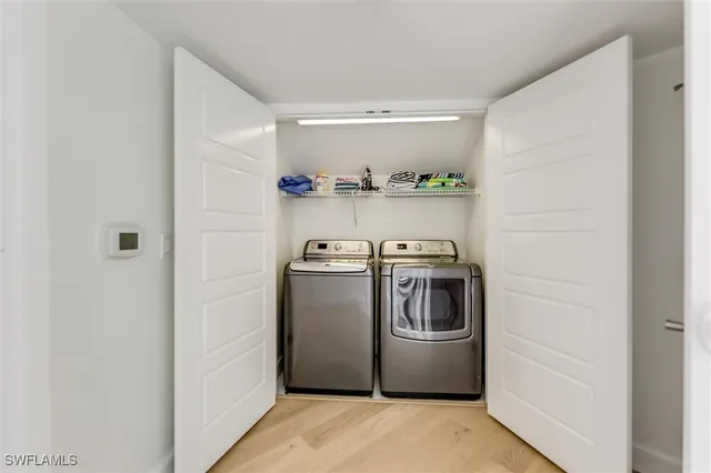 a view of a livingroom with wooden floor and a ceiling fan