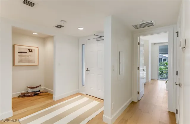 a view of a livingroom with wooden floor and a cabinet