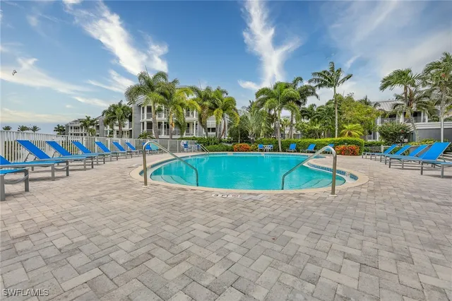 a view of a swimming pool with lounge chair