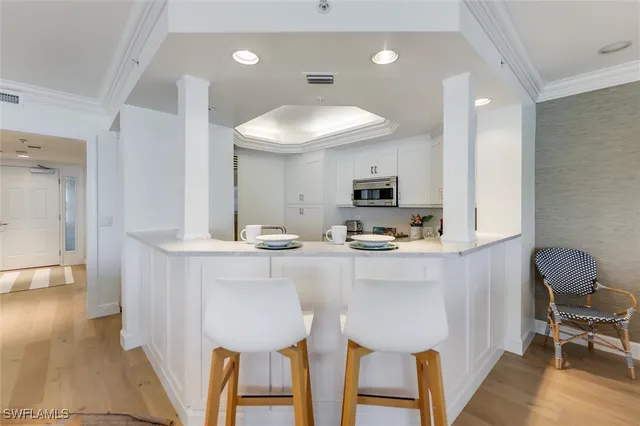 a kitchen with table chairs sink and cabinets