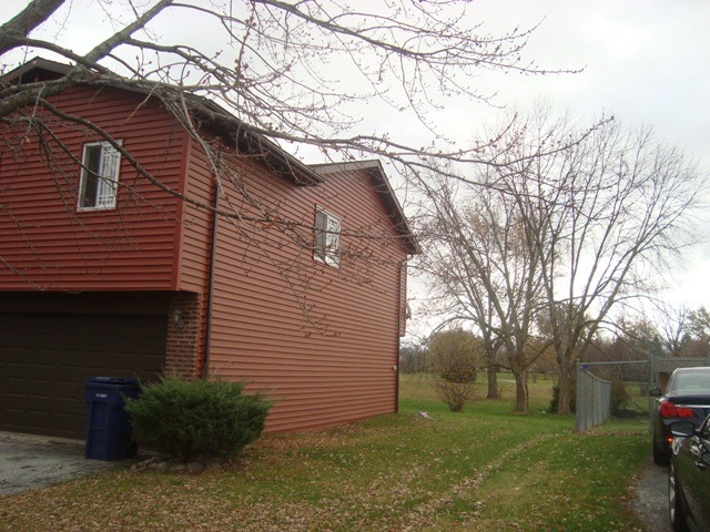 109 Cloverleaf Road Matteson, IL 60443 - Photo 2 of 25 a backyard of a house with plants and large tree