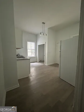 a view of a kitchen and a window in an empty room
