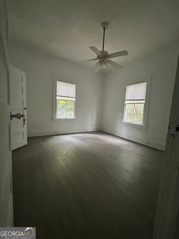 en empty room with windows and ceiling fan view