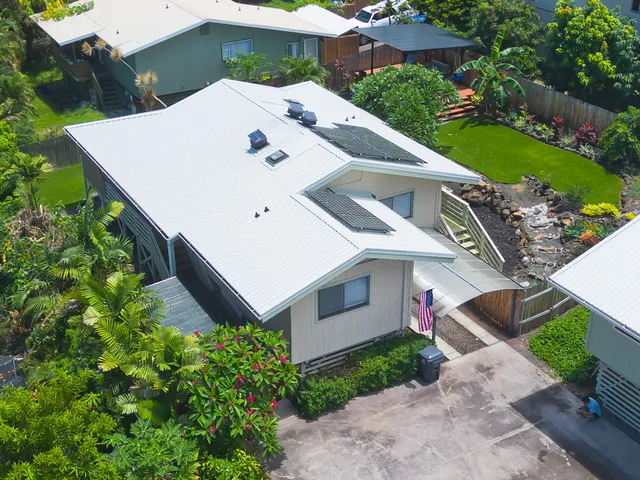 an aerial view of a house with a yard