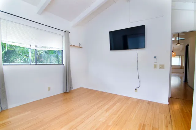 a view of a livingroom with wooden floor and flat screen tv