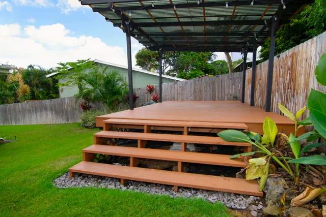 a view of a backyard with wooden fence