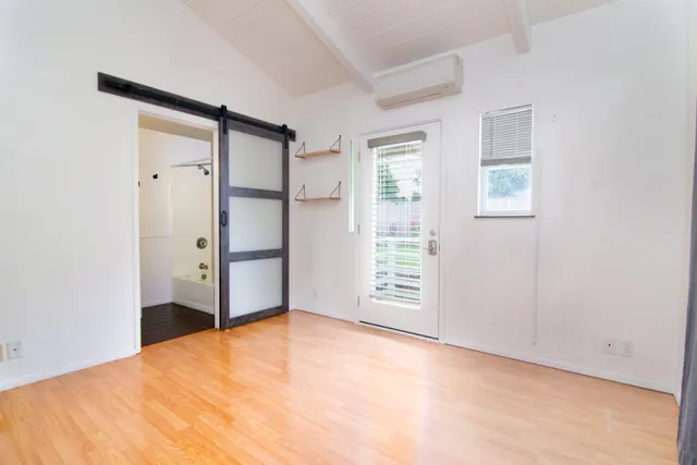 an empty room with windows and closet