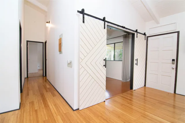 a view of a hallway view with wooden floor and staircase