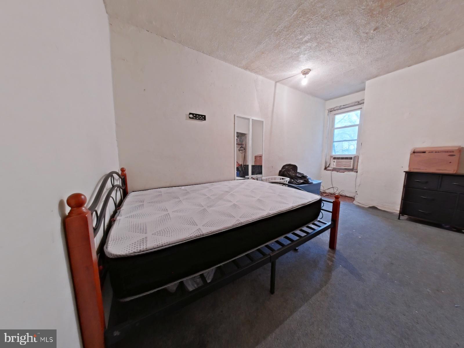 5152 Funston Street Philadelphia, PA 19139 - Photo 14 of 22 a bed sitting in a room next to a window