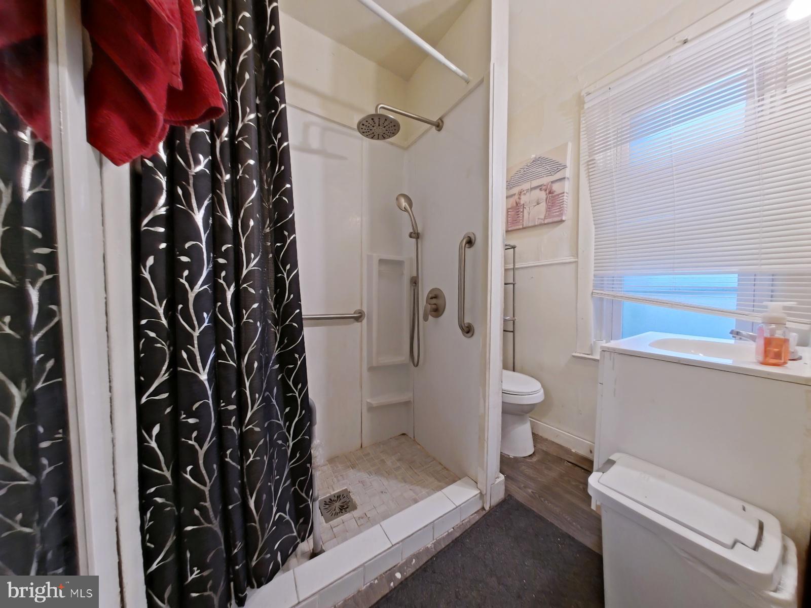 5152 Funston Street Philadelphia, PA 19139 - Photo 17 of 22 a bathroom with a shower and a toilet