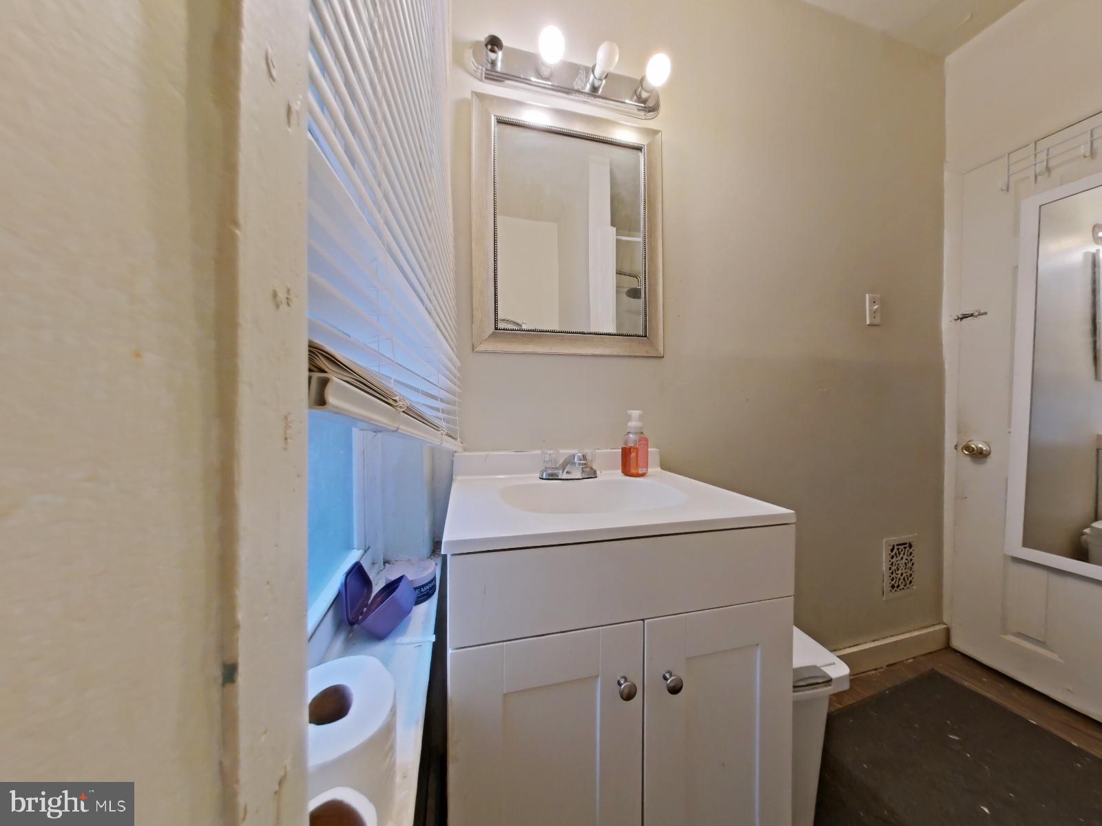 5152 Funston Street Philadelphia, PA 19139 - Photo 18 of 22 a bathroom with a sink and mirror