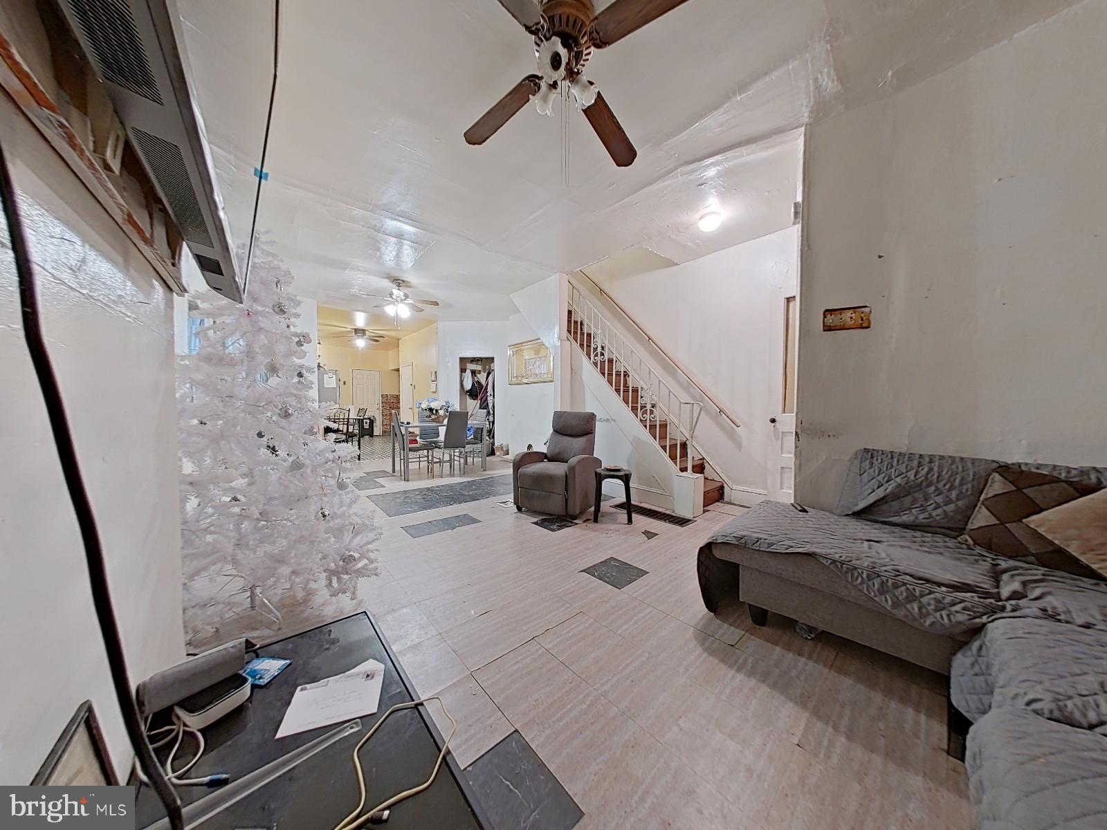 5152 Funston Street Philadelphia, PA 19139 - Photo 4 of 22 a living room with lots of furniture and a chandelier