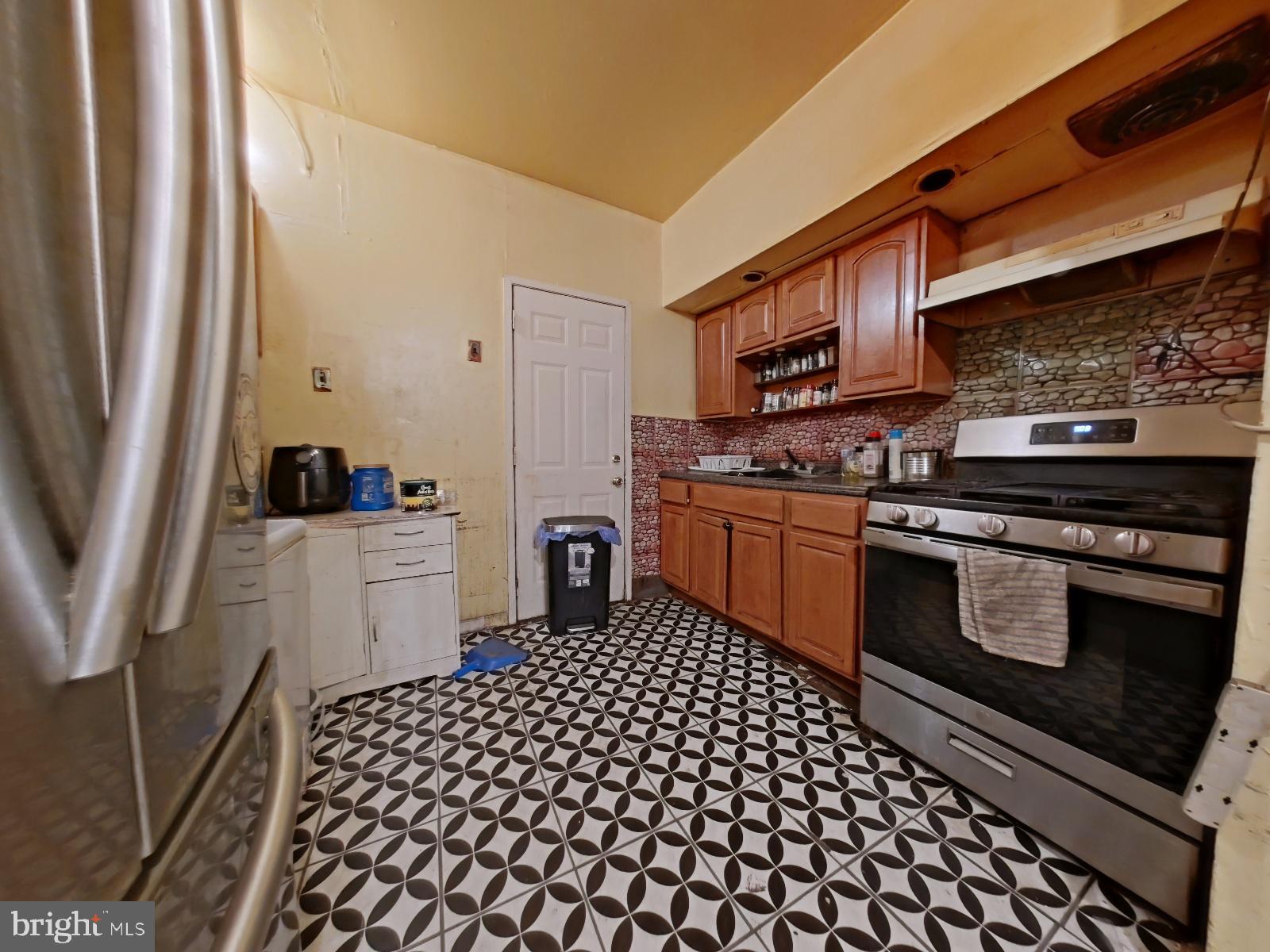5152 Funston Street Philadelphia, PA 19139 - Photo 8 of 22 a kitchen with a stove and a refrigerator