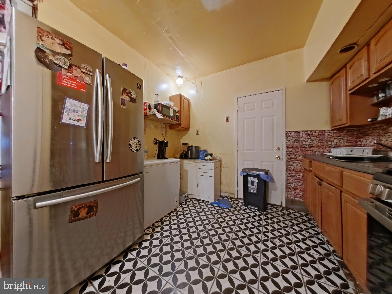 5152 Funston Street Philadelphia, PA 19139 - Photo 9 of 22 a kitchen with a refrigerator and cabinets