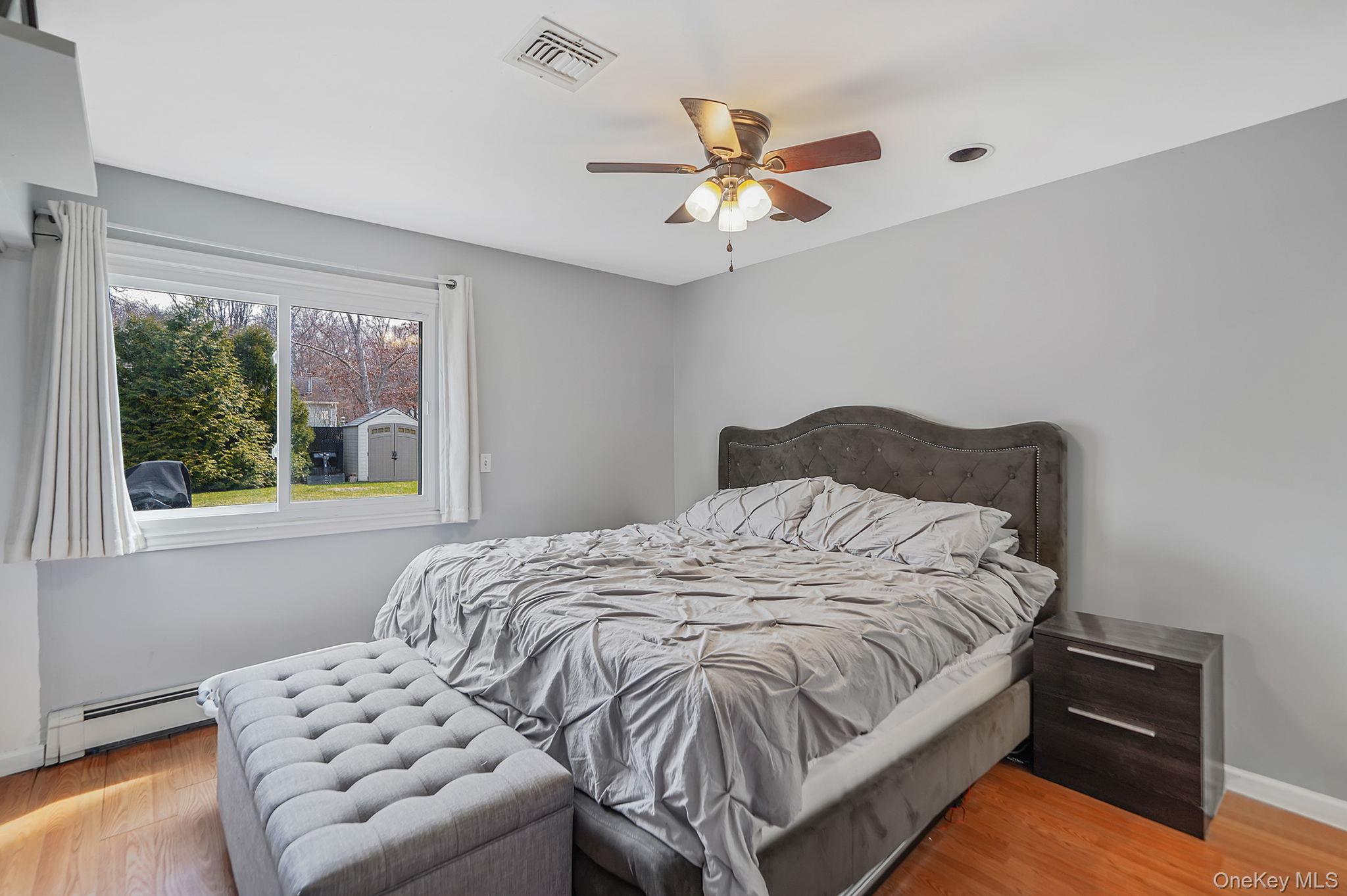 19 Goodwin Lane Coram, NY 11727 - Photo 11 of 36 a bedroom with a bed and window