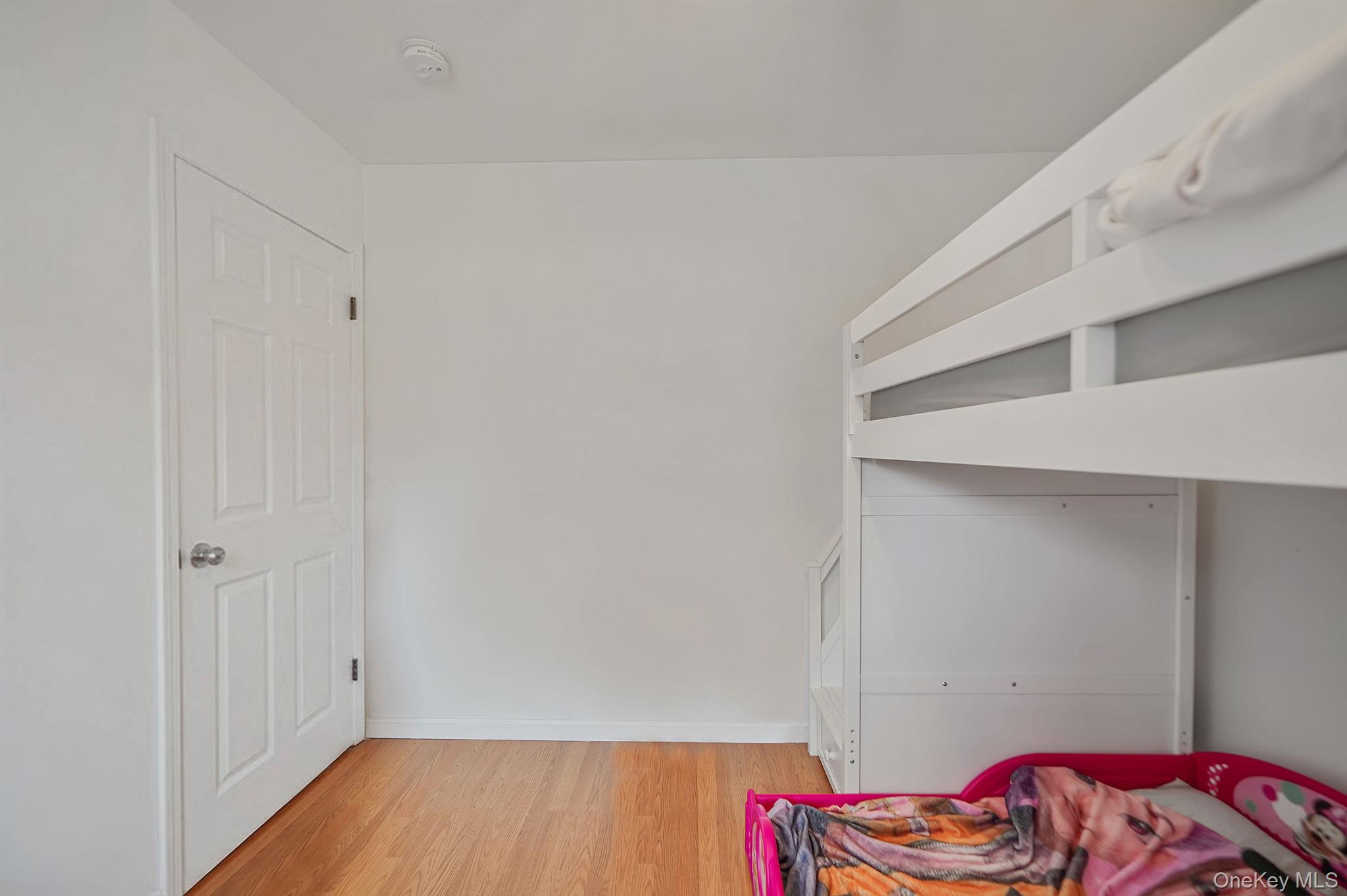 19 Goodwin Lane Coram, NY 11727 - Photo 16 of 36 a view of bedroom with a bed and wooden floor