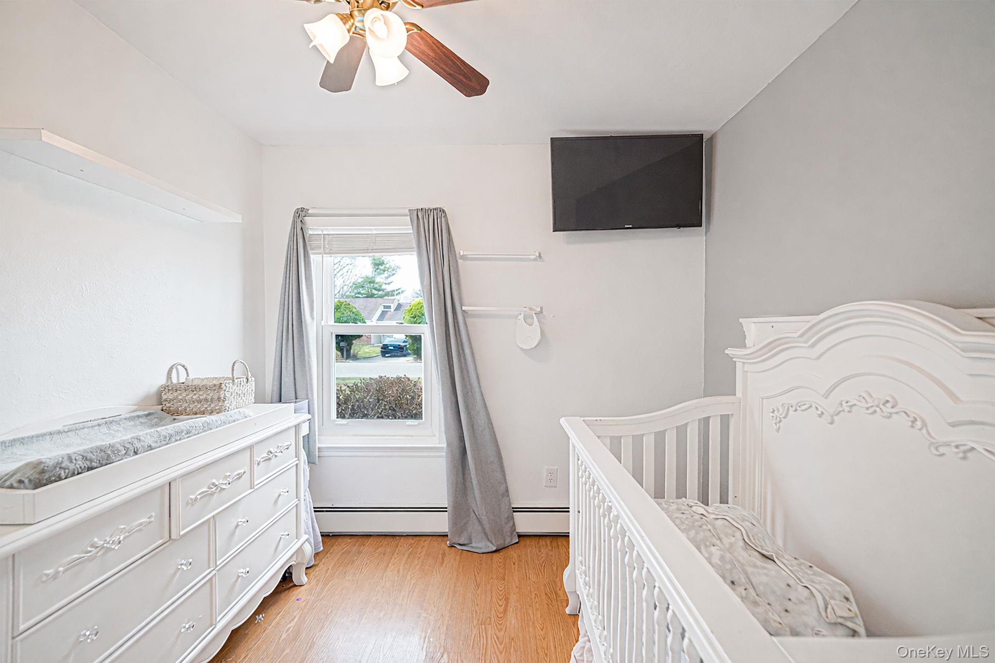 19 Goodwin Lane Coram, NY 11727 - Photo 17 of 36 a bedroom with a bed and a flat screen tv