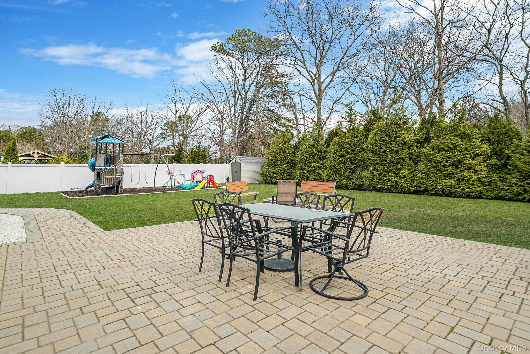 19 Goodwin Lane Coram, NY 11727 - Photo 27 of 36 a table and chairs with the view of trees