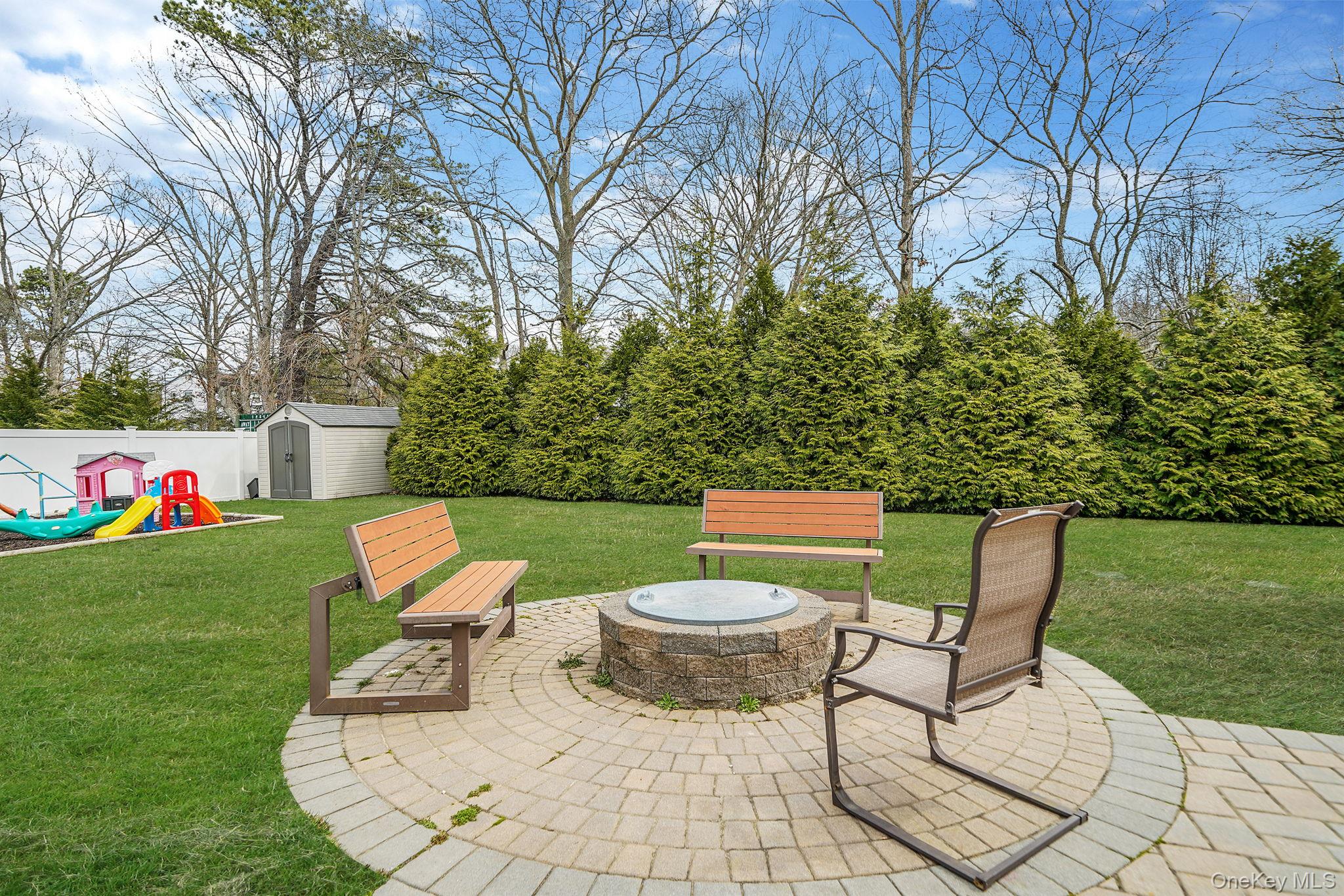 19 Goodwin Lane Coram, NY 11727 - Photo 28 of 36 a view of a chairs and table in backyard of the house