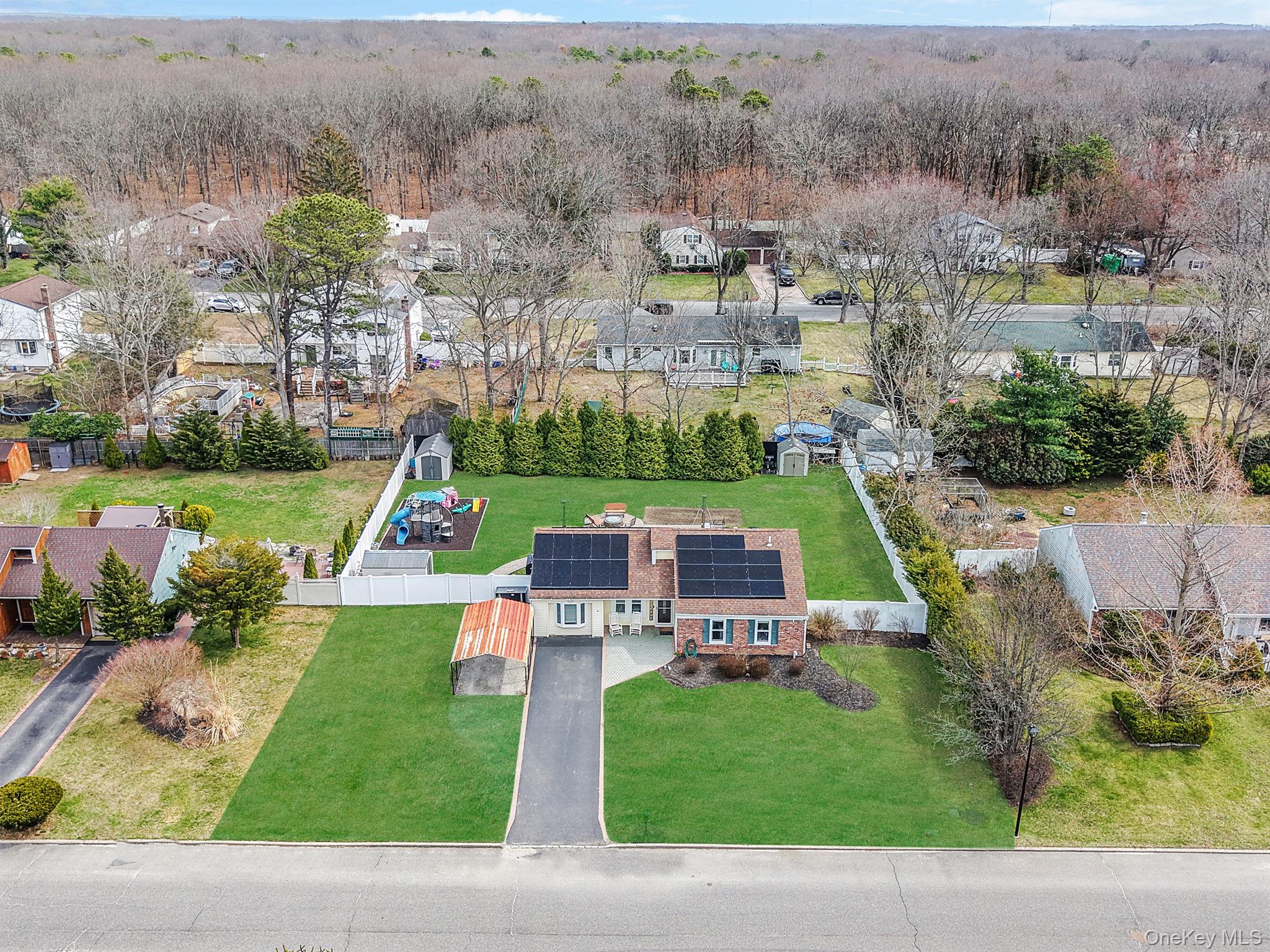 19 Goodwin Lane Coram, NY 11727 - Photo 32 of 36 an aerial view of a house with a garden and lake view