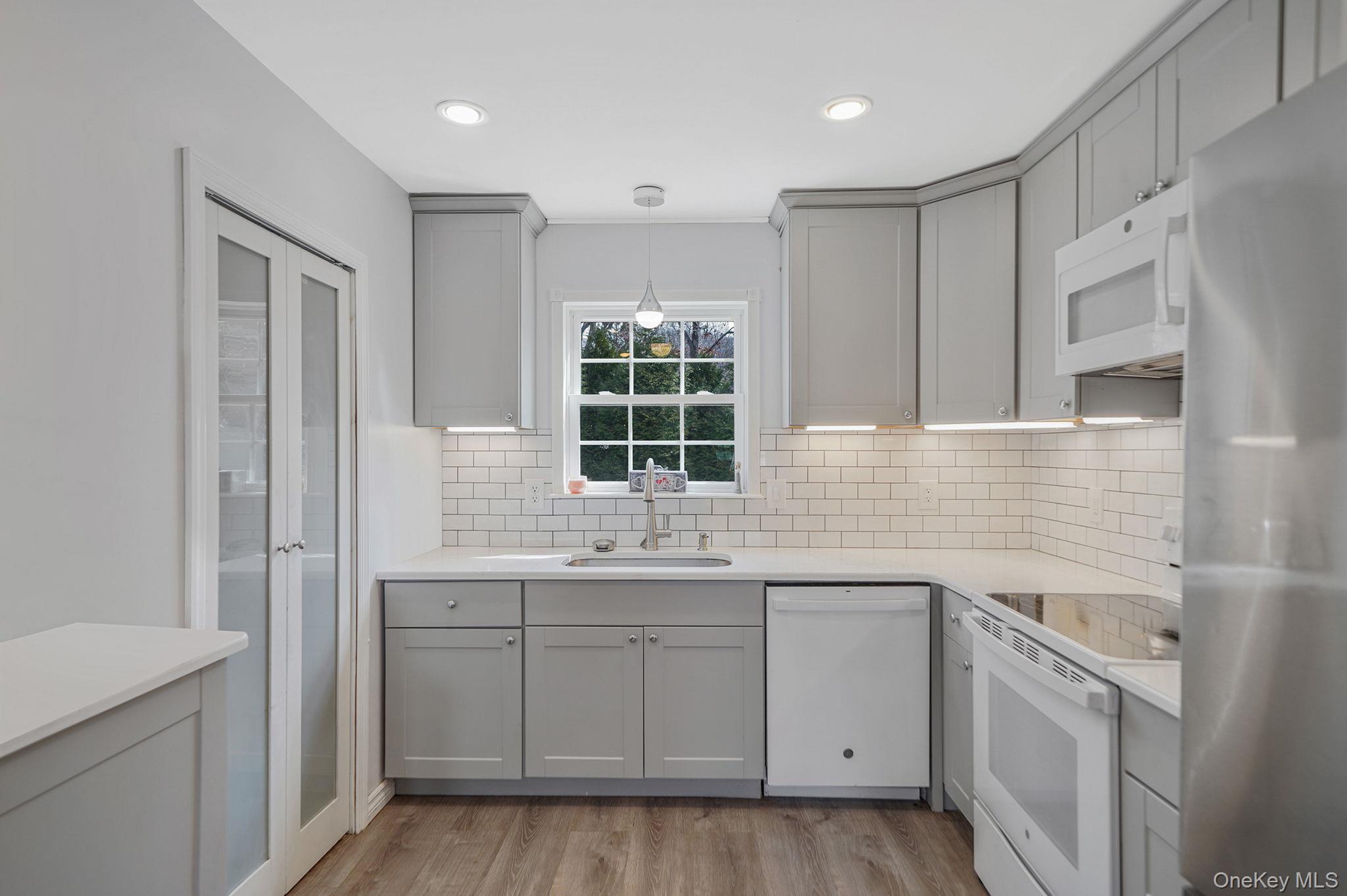 19 Goodwin Lane Coram, NY 11727 - Photo 4 of 36 a kitchen with a sink stove and cabinets