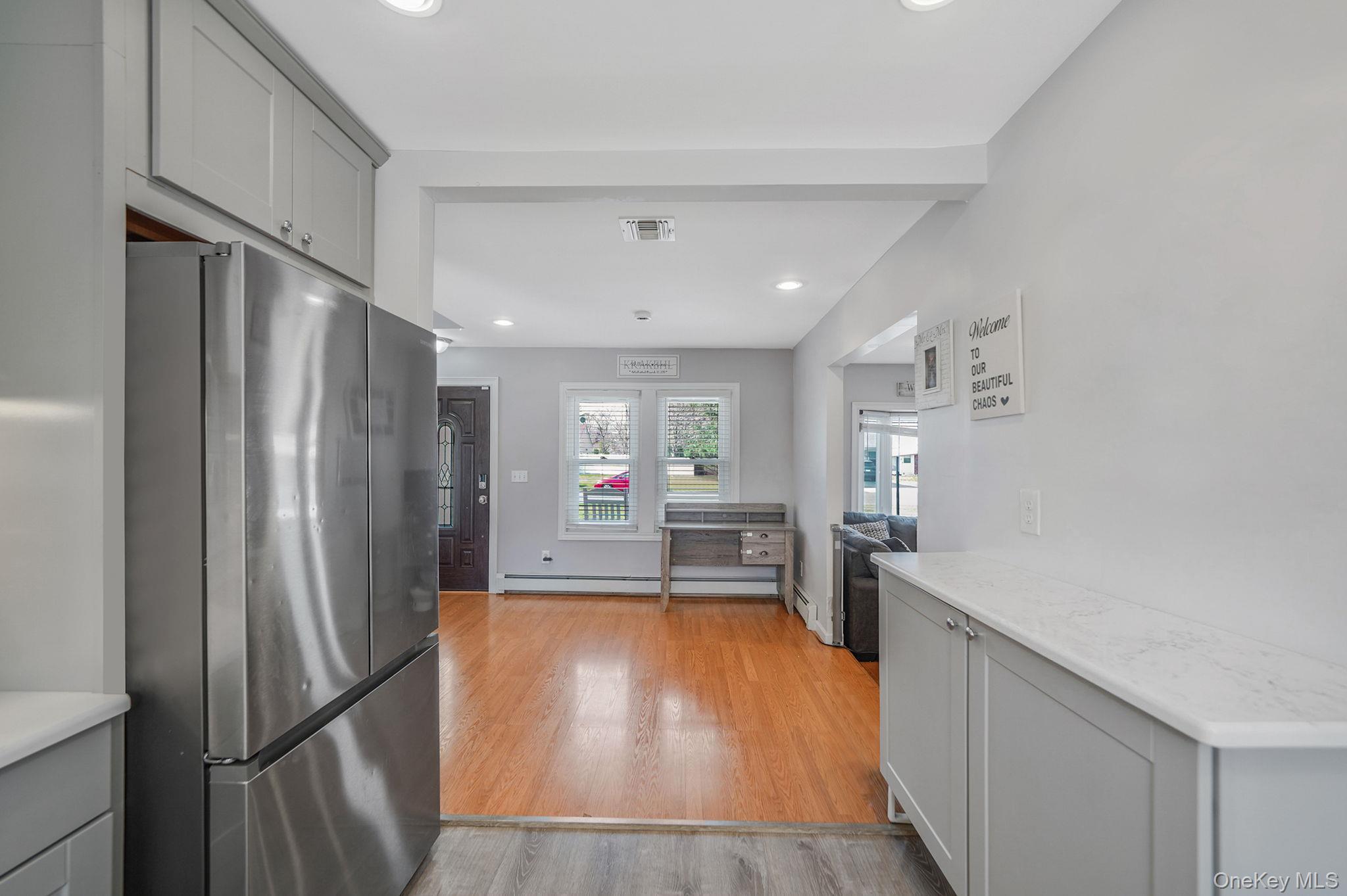 19 Goodwin Lane Coram, NY 11727 - Photo 5 of 36 a kitchen with stainless steel appliances a refrigerator and a stove top oven