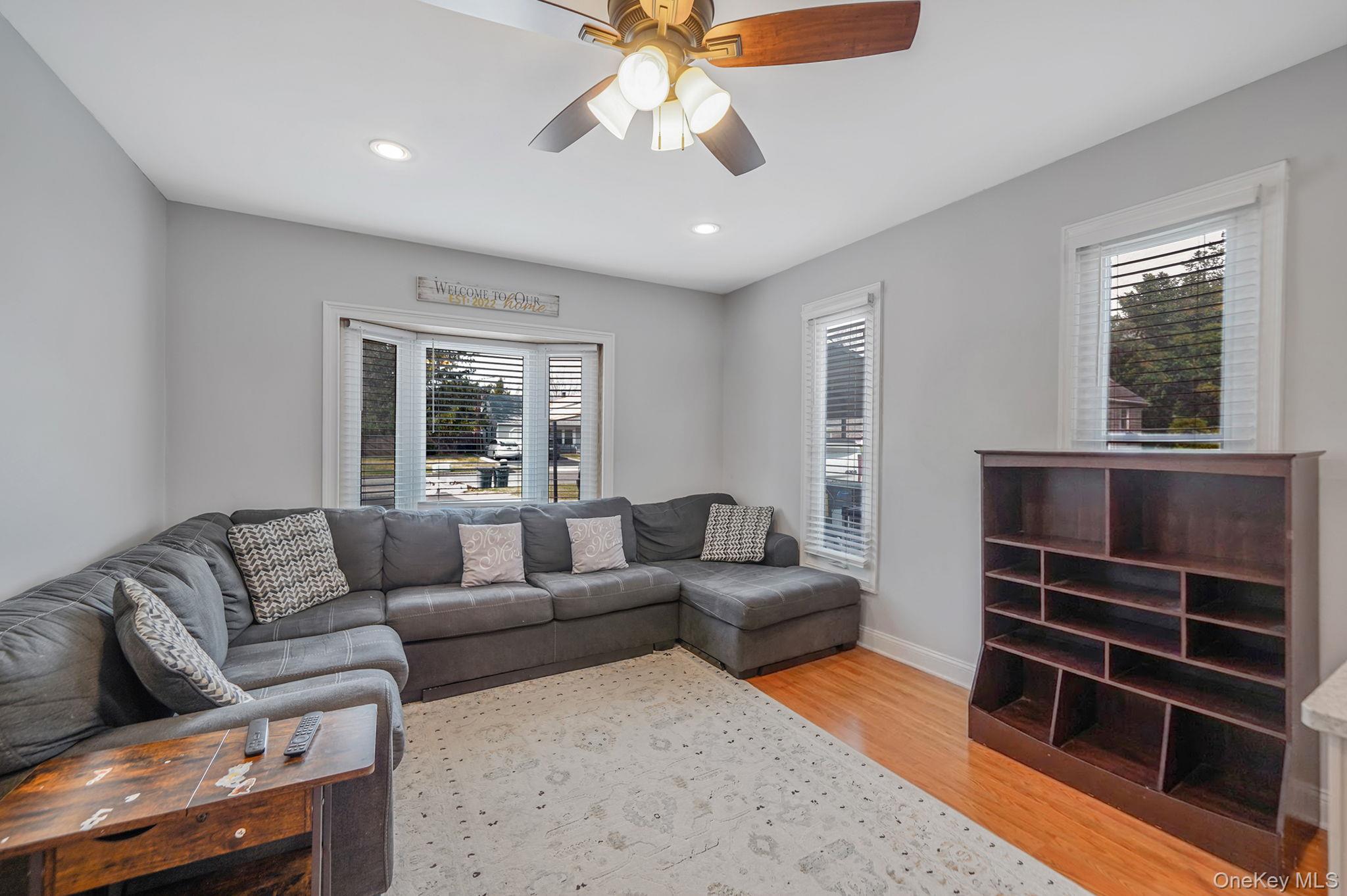 19 Goodwin Lane Coram, NY 11727 - Photo 8 of 36 a living room with furniture and a window