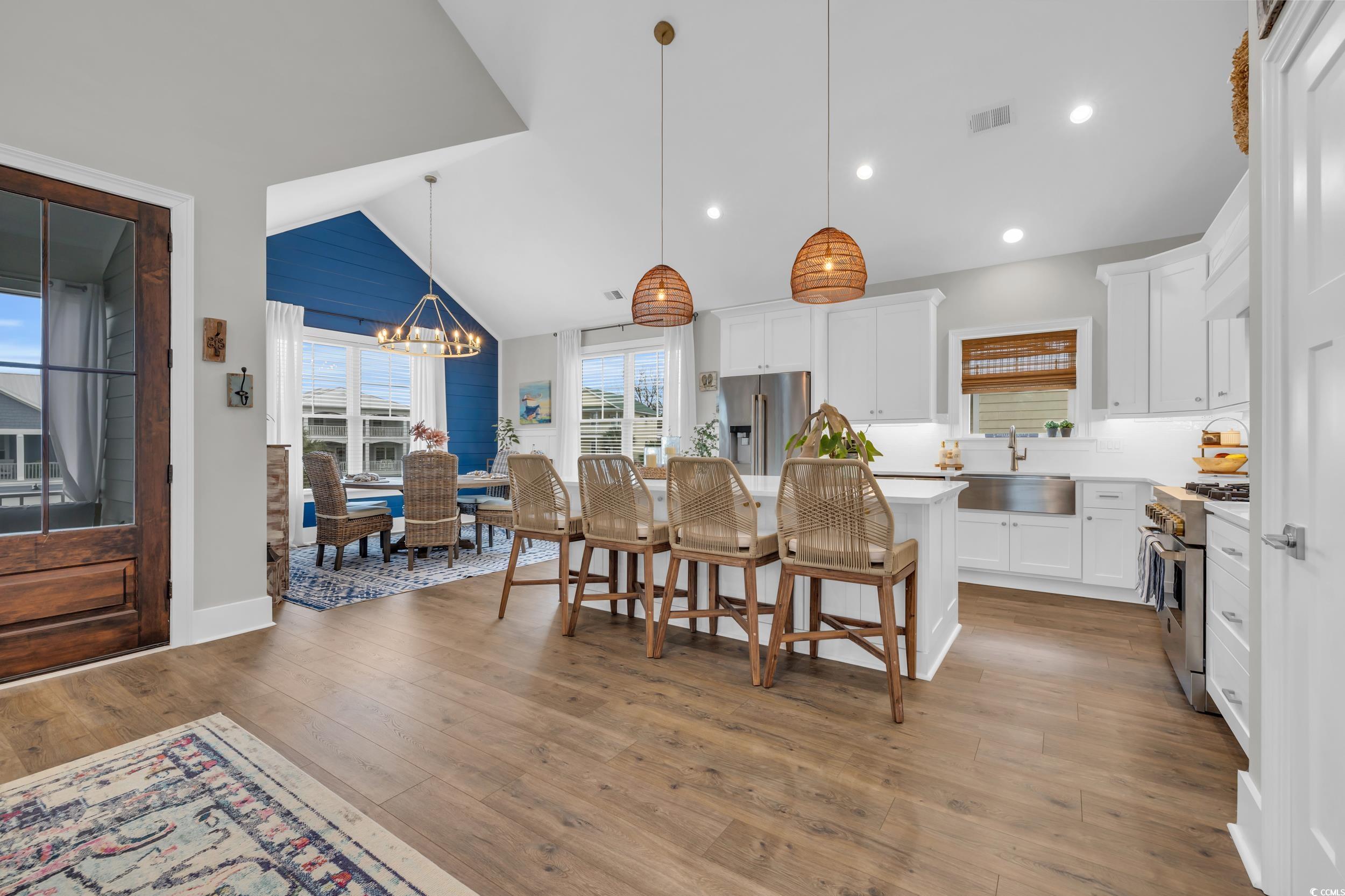 22 Trigger Fish Lane Murrells Inlet, SC 29576 - Photo 8 of 39 Kitchen with white cabinets, a kitchen island, high end appliances, and sink