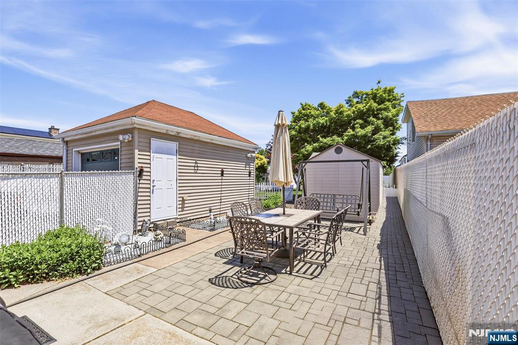 332 Riverside Avenue Lyndhurst, NJ 07071 - Photo 2 of 31 a patio with table and chairs and potted plants