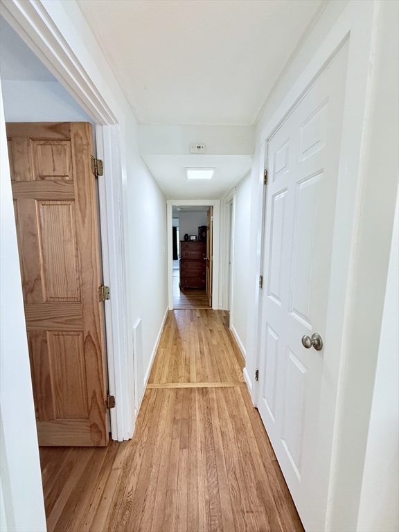 975 South Main Street Bellingham, MA 02019 - Photo 11 of 38 a view of a hallway with wooden floor and staircase